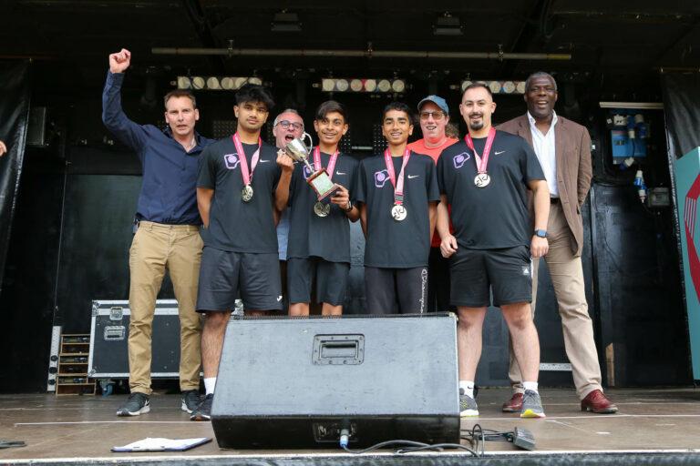 4 boys pose with trophy, alongside LYG Board member, CEO, Kate Budd and LYG Chair