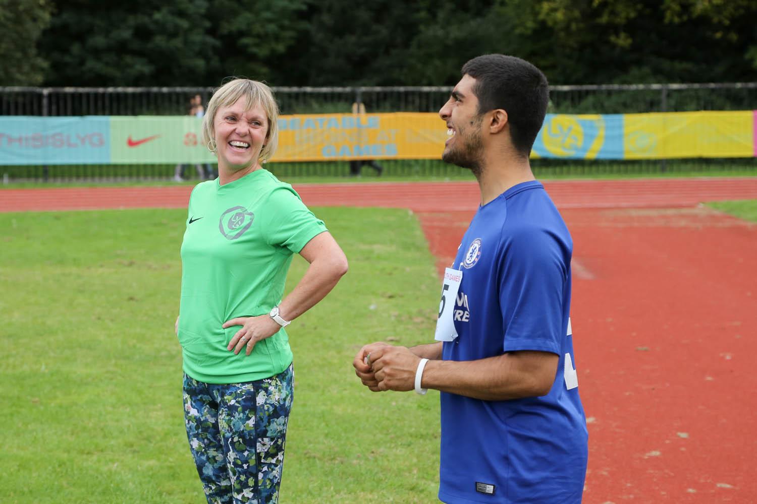 Blonde female smiles at brown skinned participant