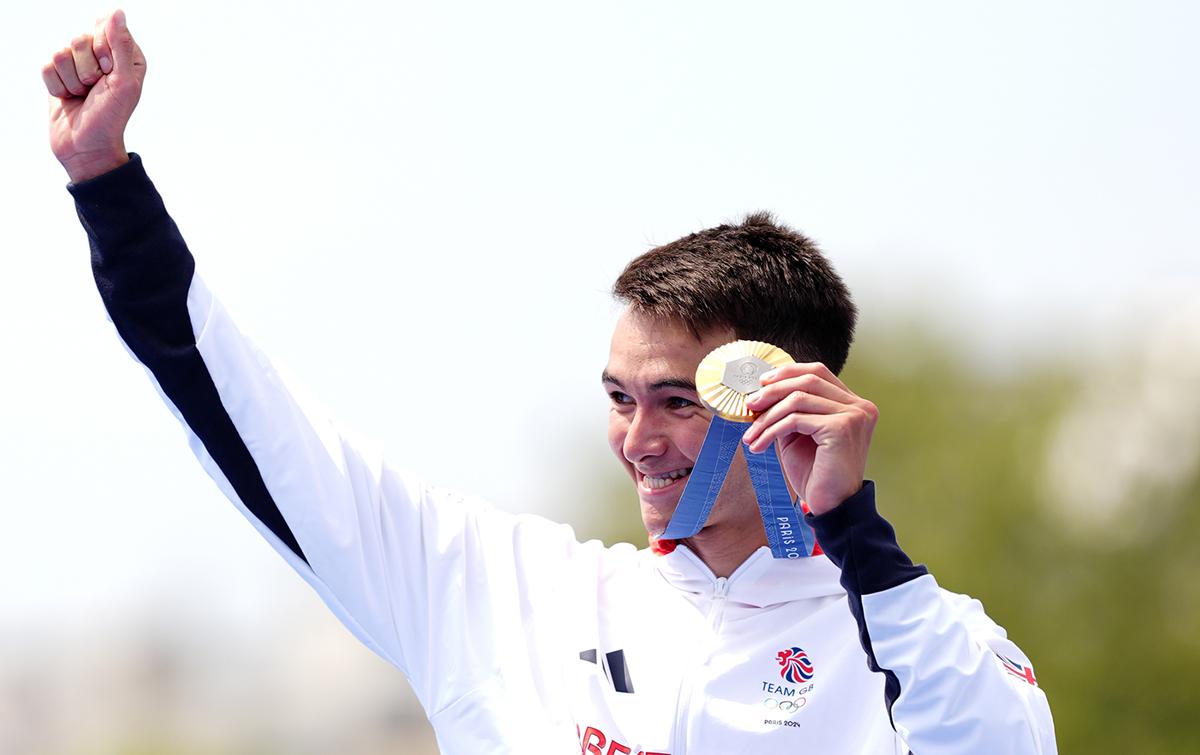 alex yee smiles and holds gold medal