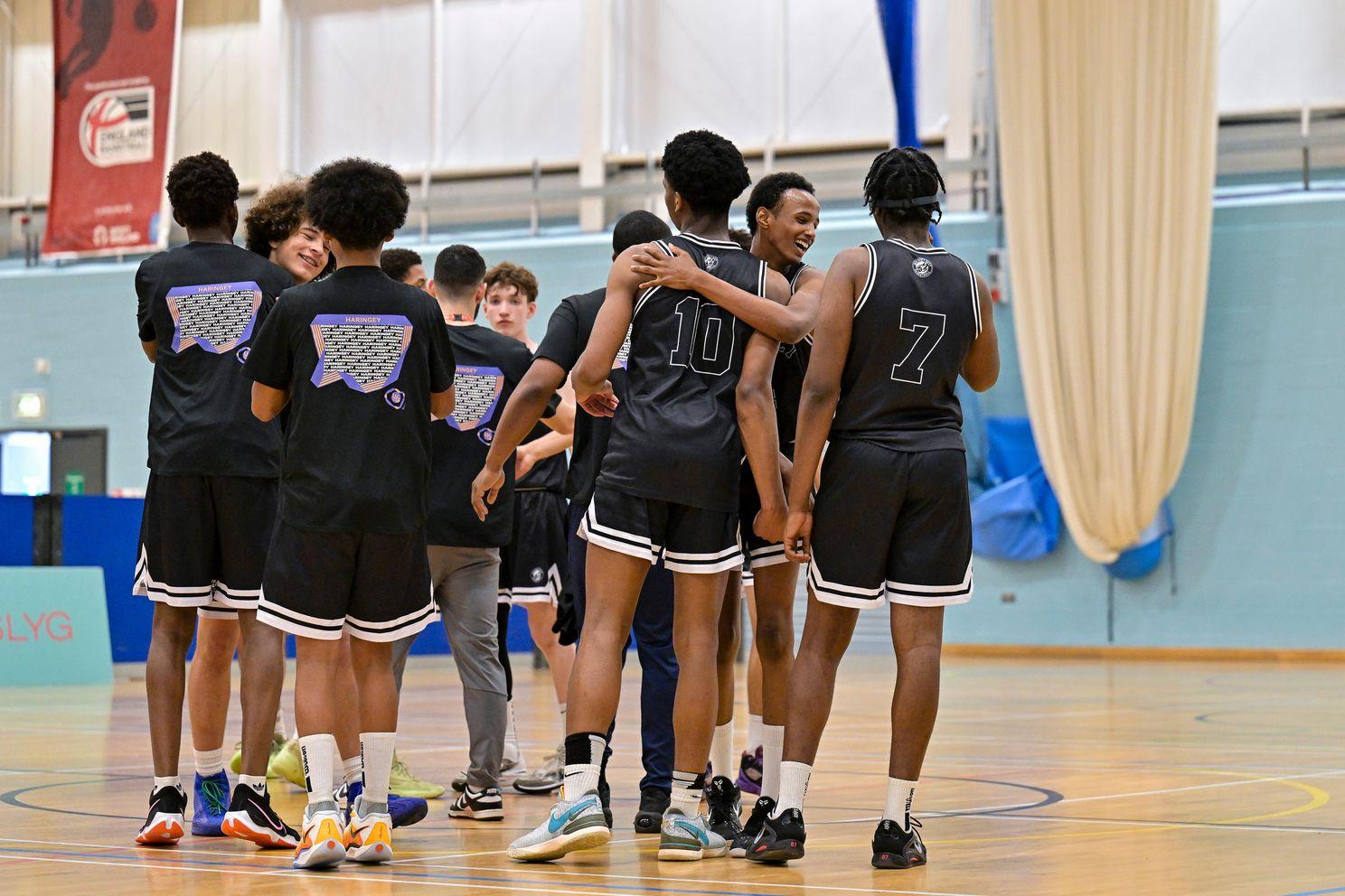 mixed ethnicity basketball players celebrate and hug