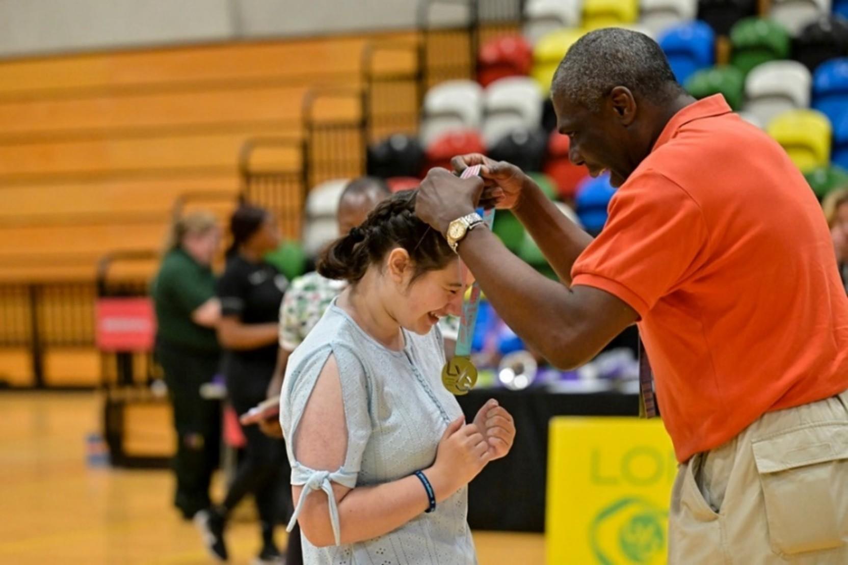 white SEND dancer female getting medal from black male