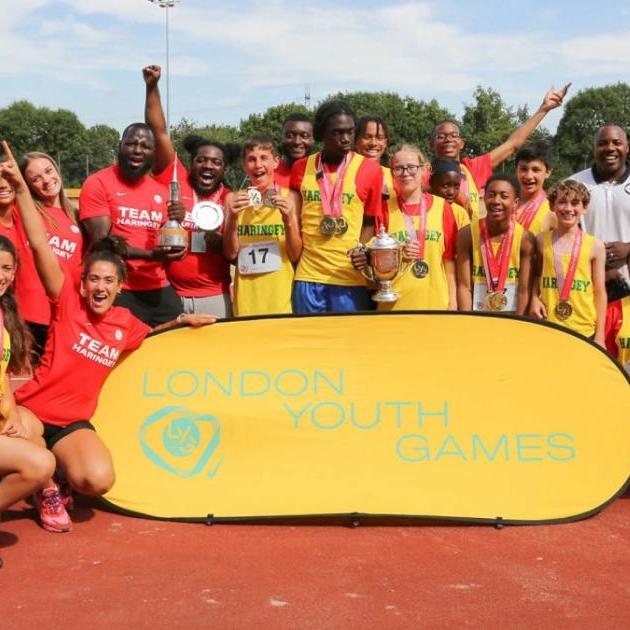 mixed ethnicity haringey group smile with trophy