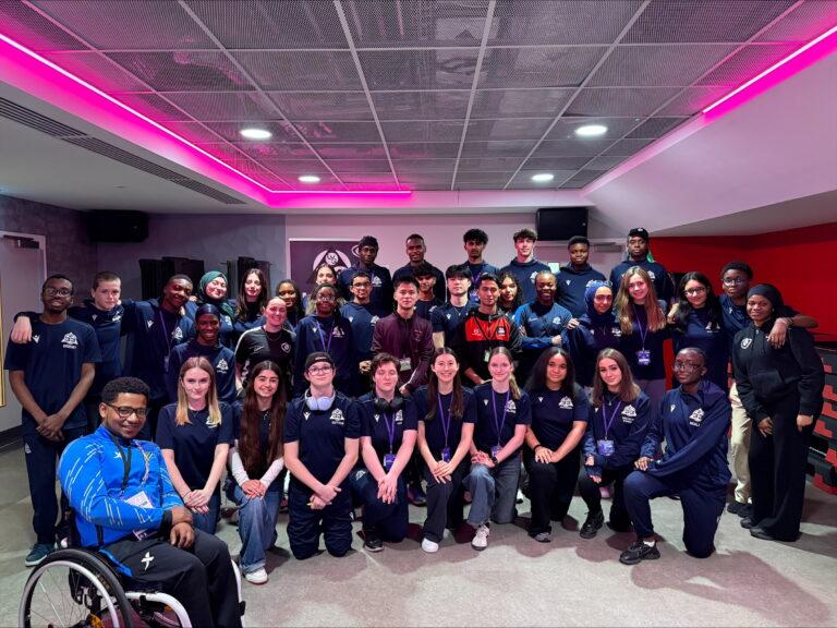 33 young people smile at aquatics centre